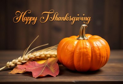 A small, orange pumpkin sits on a rustic wooden table
