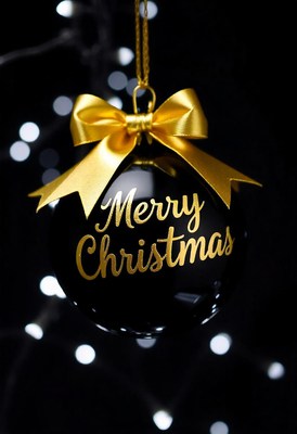 Black ornament with gold bow on dark background