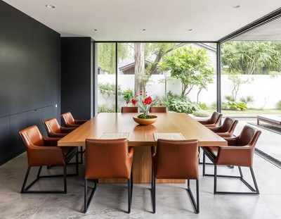 A dining room with a large wooden table and leather chairs