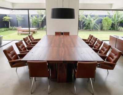 A wooden table overlooks a lush garden