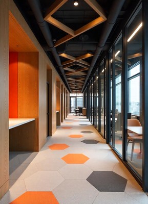 A modern office hallway with hexagonal tile flooring