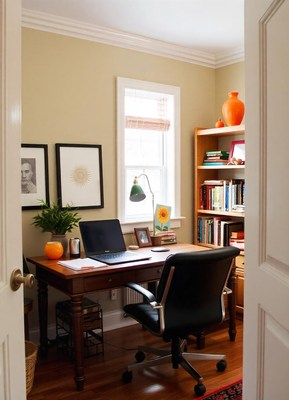 A home office with a desk, chair, and bookshelf
