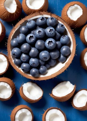 Blueberries in a coconut shell on a blue background