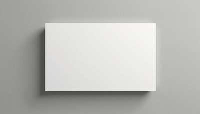 A white canvas hangs on a gray wall