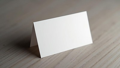 A blank card sits on a wooden table