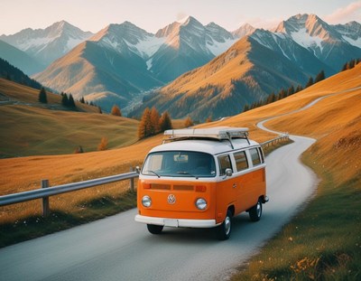 A camper van drives through a mountain pass
