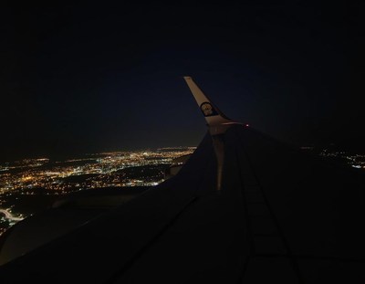 A view of city lights from an airplane at night