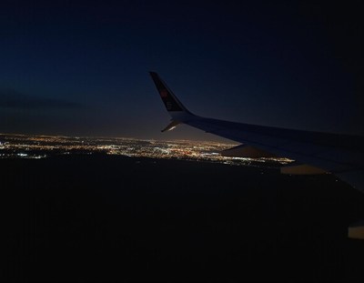 A view of city lights from an airplane at night