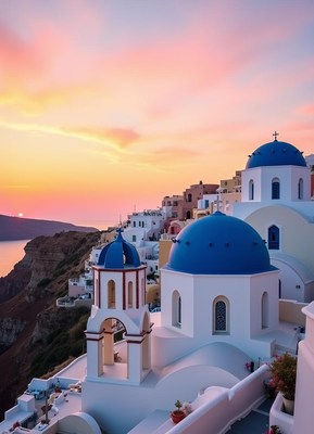 White churches with blue domes at sunset in santorini