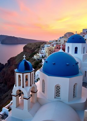 A santorini church at sunset with a view of the aegean sea
