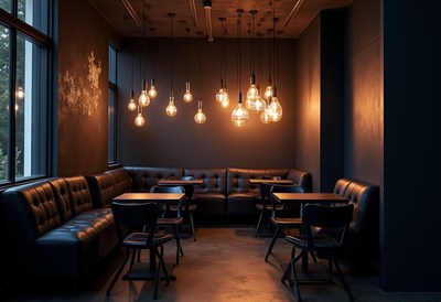 A dimly lit cafe with a booth and tables for dining