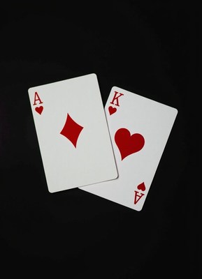 Ace of diamonds and king of hearts on black