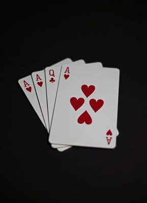 Four aces of hearts on a black background