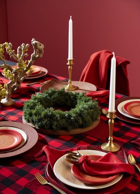 A festive table setting with candles and a wreath