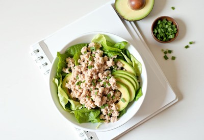 Healthy salad with avocado and chicken on a white background
