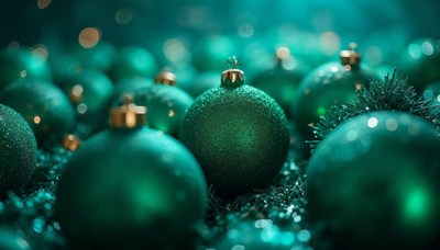 Green christmas ornaments arranged on festive background