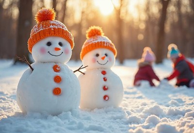 Snowmen stand cheerfully in winter park during sunset