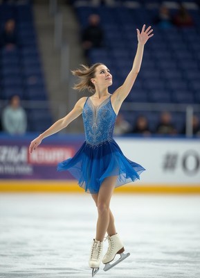 Graceful figure skater performing at ice rink competition