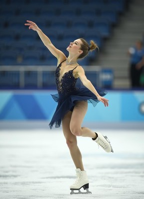 Elegant figure skater performing at an indoor rink