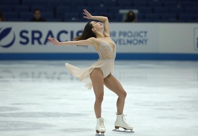 Graceful figure skater performs a routine on ice