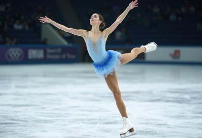 Skater performs an elegant routine on ice during competition