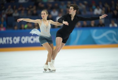 Beautiful pair ice skating in a competition venue