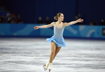 Skater performs elegant routine on ice during competition