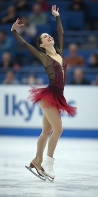 Skater performs elegant routine in vibrant red costume