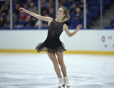 Skater performs elegant routine on ice in competition