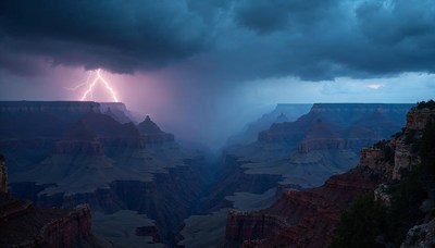 Lightning strikes over the canyon during a stormy twilight