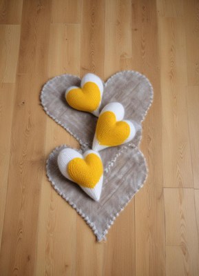 Knitted heart decorations on a cozy rug