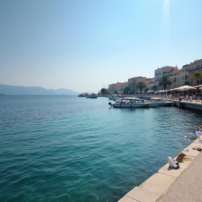 Sunny waterfront in a coastal town with boats at dock