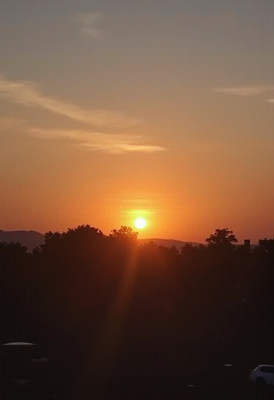 Sunset over trees and mountains