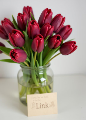 Beautiful red tulips in a vase on a table