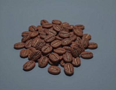 Coffee beans arranged on a blue surface