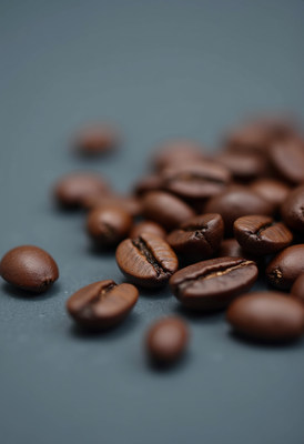 Freshly roasted coffee beans on a dark background