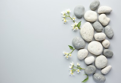 Stones and flowers on a gray surface
