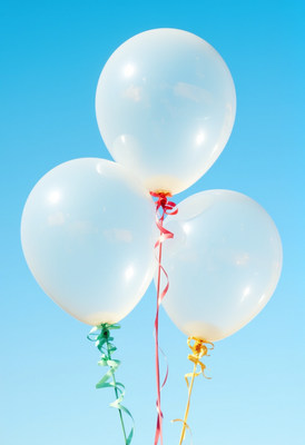 Colorful balloons floating in a blue sky