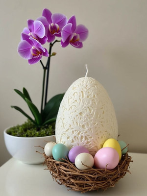 Decorative easter egg and orchid arrangement on table
