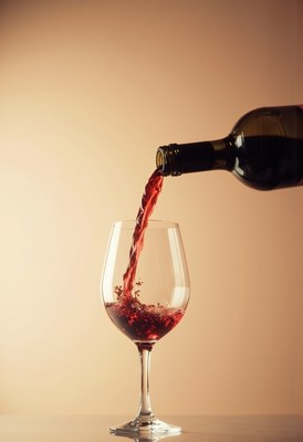 Pouring red wine into a glass during a cozy evening