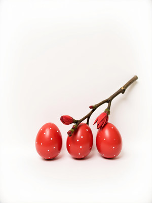 Bright red decorative eggs with flower branch display