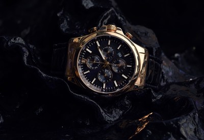 Elegant gold watch on dark textured surface