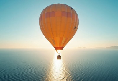 Colorful hot air balloon floating over tranquil water
