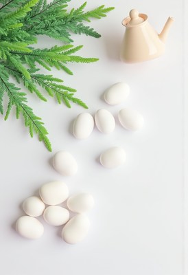 White eggs in a small watering can arrangement