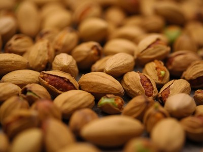 Roasted pistachios displayed on a wooden surface
