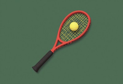 Tennis racket and ball on a green background