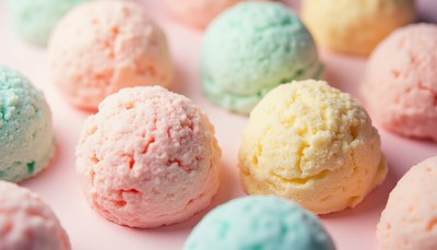 Colorful ice cream scoops arranged on a pastel surface