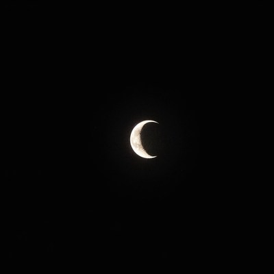 Crescent moon shining brightly in the night sky