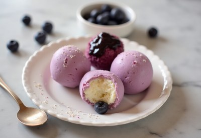 Delicious purple ice cream with blueberries served on plate