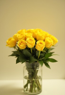 Beautiful yellow roses in a clear glass vase